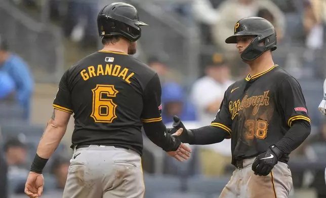 Pittsburgh Pirates' Nick Yorke (38) celebrates with Yasmani Grandal (6) after they scored on a two-run home run by Yorke during the ninth inning of a baseball game, Saturday, Sept. 28, 2024, in New York. (AP Photo/Frank Franklin II)