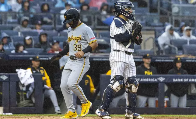 Pittsburgh Pirates Nick Gonzales, left, scores a run during the third inning of a baseball game against the New York Yankees, Sunday, Sept. 29, 2024, in New York. (AP Photo/Eduardo Munoz Alvarez)