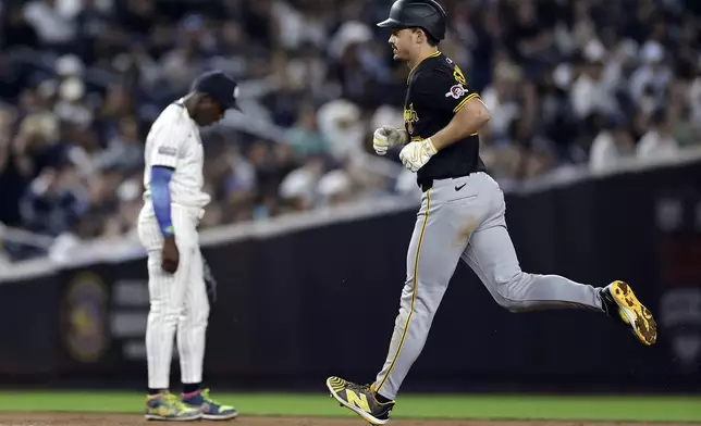 Pittsburgh Pirates' Bryan Reynolds, right, rounds the bases past New York Yankees third baseman Jazz Chisholm Jr., left, after hitting a two-run home run during the eighth inning of a baseball game Friday, Sept. 27, 2024, in New York. (AP Photo/Adam Hunger)