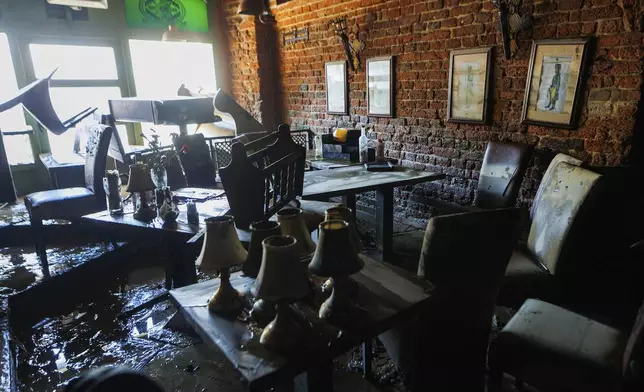 A caffe is seen damaged after the high flood waves passed through the town, in Nysa, southwestern Poland, on Wednesday, Sept. 18, 2024. (AP Photo/Krzysztof Zatycki)