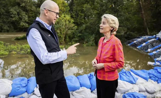 European Commmission President Ursula von der Leyen, right, talks to Jakub Mazur, First Deputy Mayor of Wroclaw, next to the river Bystrzyca near Woclaw, Poland, Thursday, Sept. 19, 2024. (Christoph Soeder/DPA via AP, Pool)