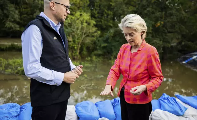 European Commmission President Ursula von der Leyen, right, talks to Jakub Mazur, First Deputy Mayor of Wroclaw, next to the river Bystrzyca near Woclaw, Poland, Thursday, Sept. 19, 2024. (Christoph Soeder/DPA via AP, Pool)