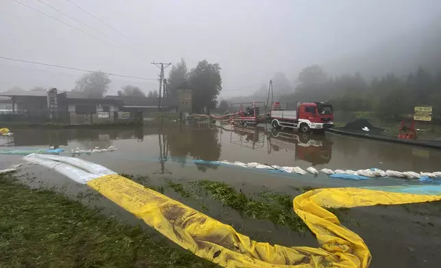 This handout photo provided by the Polish fire department, shows firefighters pump water and mud from city streets and help clean the city of Głogow that was hit by a high flood wave, in Głogow, southwestern Poland, on Wednesday, Sept. 18, 2024. (KG PSP via AP)