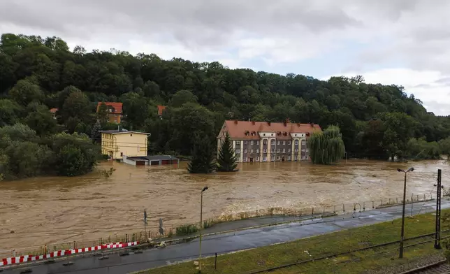 Garages and a house flooded in the town Kłodzko, in Poland's southwest, Sunday, Sept. 15, 2024, after days of unusually heavy rain. (AP Photo/Krzysztof Zatycki)