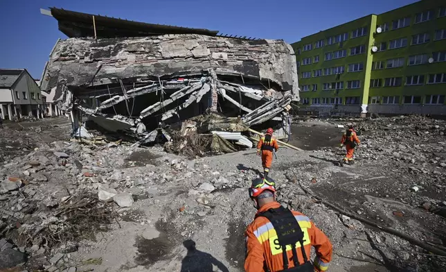 On this handout photo provided by the State Fire Service of Poland, firefighters inspecting safety of houses following heavy flooding in the town of Stronie Slaskie, southwestern Poland, Wednesday, Sept. 18, 2024. (Tomasz Fijołek/KG PSP via AP)