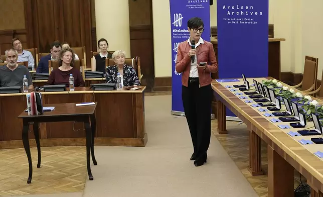 The director of Germany's Arolsen Archives, Floriane Azoulay, talks to the relatives of 12 inmates of World War II Nazi Germany's concentration camps at the start of a ceremony in which the relatives were given back personal items and jewellery that the Nazis had seized from them during the war and which were recently stored at the archives, in Warsaw, Poland, Tuesday Sept. 10, 2024. (AP Photo/Czarek Sokolowski)