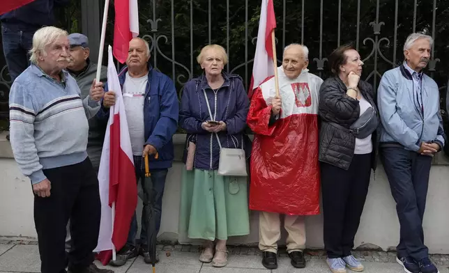 Backers of the right-wing opposition party Law and Justice take part in a protest ally of a few thousand people against the policies of Prime Minister Donald Tusk's Cabinet before the Ministry of Justice, in Warsaw, Poland, Saturday Sept. 14, 2024. (AP Photo/Czarek Sokolowski)