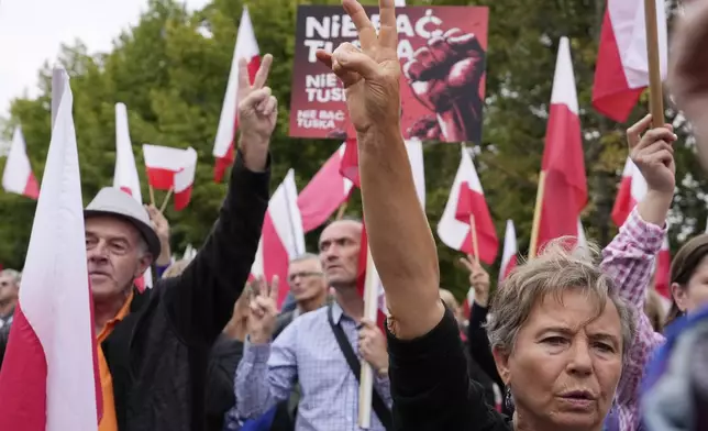 Backers of the right-wing opposition party Law and Justice take part in a protest ally of a few thousand people against the policies of Prime Minister Donald Tusk's Cabinet before the Ministry of Justice, in Warsaw, Poland, Saturday Sept. 14, 2024. (AP Photo/Czarek Sokolowski)