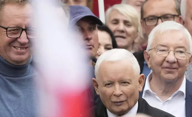 Leader of Poland's right-wing opposition party Law and Justice, Jaroslaw Kaczynski, front, attends the party's protest rally of a few thousand backers against the policies of Prime Minister Donald Tusk's Cabinet before the Ministry of Justice, in Warsaw, Poland, Saturday Sept. 14, 2024. (AP Photo/Czarek Sokolowski)