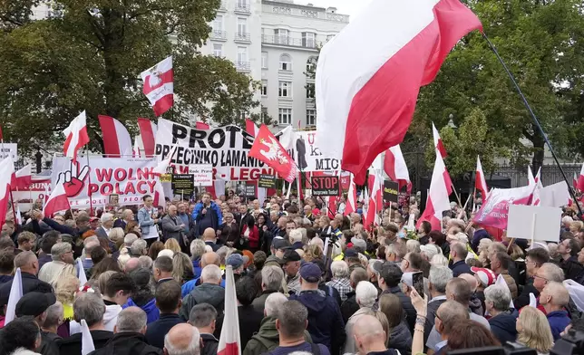 Backers of the right-wing opposition party Law and Justice take part in a protest ally of a few thousand people against the policies of Prime Minister Donald Tusk's Cabinet before the Ministry of Justice, in Warsaw, Poland, Saturday Sept. 14, 2024. (AP Photo/Czarek Sokolowski)