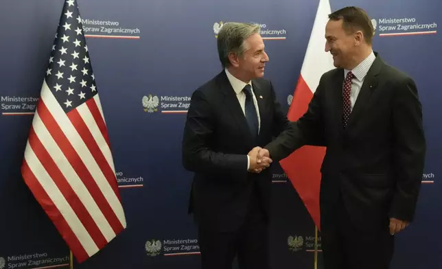 U.S. Secretary of State Antony Blinken, left, welcomes by Polish Foreign Minister Radosław Sikorski, right, for talks in Warsaw, Poland, Thursday, Sept. 12, 2024. (AP Photo/Mark Schiefelbein, Pool)