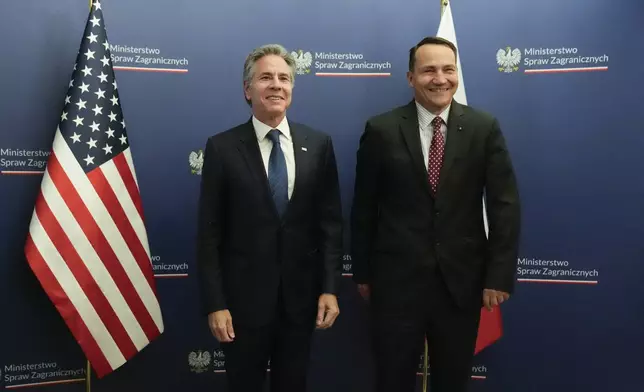 U.S. Secretary of State Antony Blinken, left, welcomes by Polish Foreign Minister Radosław Sikorski, right, for talks in Warsaw, Poland, Thursday, Sept. 12, 2024. (AP Photo/Mark Schiefelbein, Pool)