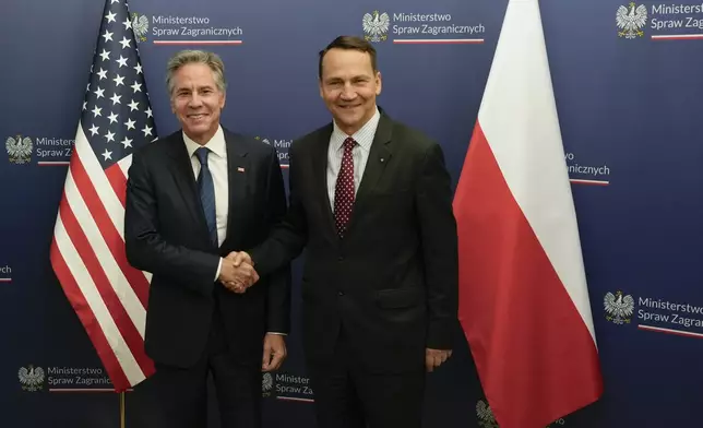 U.S. Secretary of State Antony Blinken, left, welcomes by Polish Foreign Minister Radosław Sikorski, right, for talks in Warsaw, Poland, Thursday, Sept. 12, 2024. (AP Photo/Czarek Sokolowski)