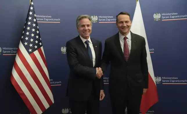 U.S. Secretary of State Antony Blinken, left, welcomes by Polish Foreign Minister Radosław Sikorski, right, for talks in Warsaw, Poland, Thursday, Sept. 12, 2024. (AP Photo/Mark Schiefelbein, Pool)