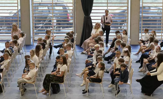 Children gather for the ceremonial first day of school in Warsaw, Poland, Monday, Sept 2, 2024. (AP Photo/Czarek Sokolowski)