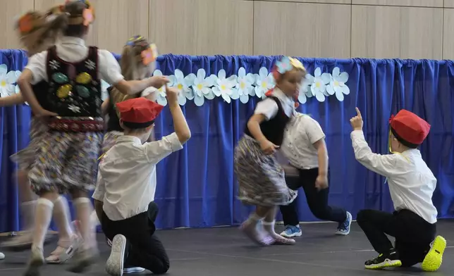 Children perform on the ceremonial first day of school in Warsaw, Poland, on Monday, Sept 2, 2024. (AP Photo/Czarek Sokolowski)