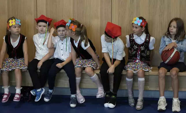 Children on the ceremonial first day of school in Warsaw, Poland, on Monday, Sept 2, 2024. (AP Photo/Czarek Sokolowski)