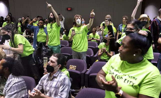 Opponents of the under-construction law enforcement training center known to some as Cop City disrupt the City Council meeting at City Hall in Atlanta on Monday, Sept. 16, 2024. (Arvin Temkar/Atlanta Journal-Constitution via AP)