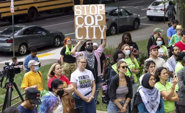 Opponents of an under-construction law enforcement training center that critics call "Cop City," protest at City Hall in Atlanta, Monday, Sept. 16, 2024. (Arvin Temkar/Atlanta Journal-Constitution via AP)