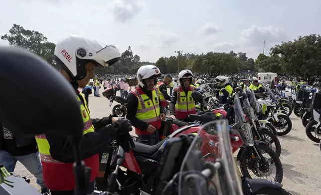 A group of Lisbon firefighters motorcyclists get on their bikes to leave after taking part in the IX Pilgrimage of the Blessing of Helmets that draws tens of thousands to the Roman Catholic holy shrine of Fatima, in Fatima, Portugal, Sunday, Sept. 22, 2024. (AP Photo/Ana Brigida)