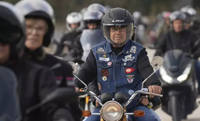 Motorcyclists arrive at the parking lots around the Roman Catholic holy shrine of Fatima to attend the IX Pilgrimage of the Blessing of Helmets that draws tens of thousands, in Fatima, Portugal, Sunday, Sept. 22, 2024. (AP Photo/Ana Brigida)