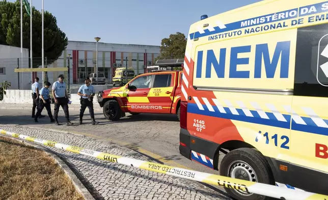 Police officers cordon off the area outside a school following a stabbing attack in Azambuja near Lisbon, Tuesday, Sept. 17, 2024. (AP Photo/Ana Brigida)