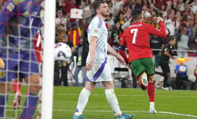 Portugal's Cristiano Ronaldo, right, celebrates after scoring his side's second goal during the UEFA Nations League soccer match between Portugal and Scotland at the Luz stadium in Lisbon, Portugal, Sunday, Sept. 8, 2024. (AP Photo/Armando Franca)