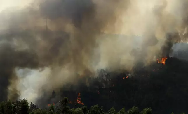 Wildfire advances near Sever do Vouga, a town in northern Portugal that has been surrounded by forest fires, Tuesday, Sept. 17, 2024. (AP Photo/Bruno Fonseca)