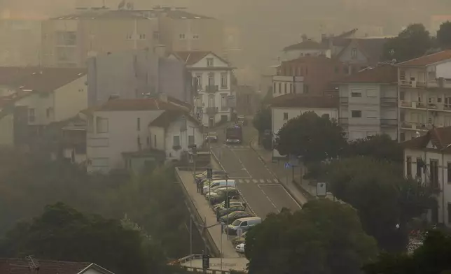 Smoke fills the air in Sever do Vouga, a town in northern Portugal that has been surrounded by forest fires, Monday, Sept. 16, 2024. (AP Photo/Bruno Fonseca)