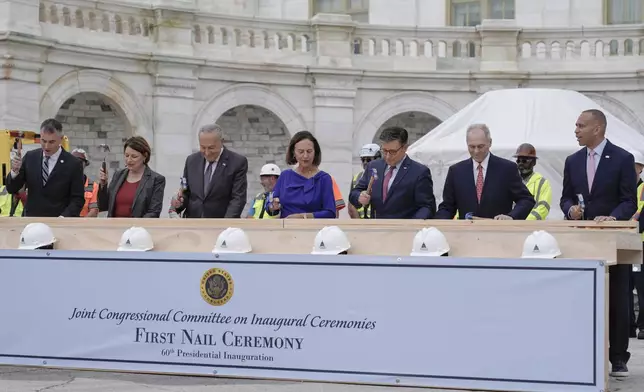 Congress members hammer in the first nails at the First Nail Ceremony marking the beginning of construction of the 2025 Presidential Inauguration platform on the steps of the Capitol, Wednesday, Sept. 18, 2024, in Washington. (AP Photo/Mariam Zuhaib)