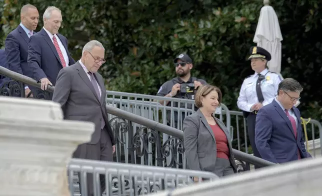 From left, House Minority Leader Hakeem Jeffries, D-N.Y., House Majority Leader Steve Scalise, R-La., Senate Majority Leader Chuck Schumer, D-N.Y., Sen. Amy Klobuchar, D-Minn., and Speaker of the House Mike Johnson, R-La., arrive to the First Nail Ceremony marking the beginning of construction of the 2025 Presidential Inauguration platform, on the steps of the Capitol, Wednesday, Sept. 18, 2024, in Washington. (AP Photo/Mariam Zuhaib)