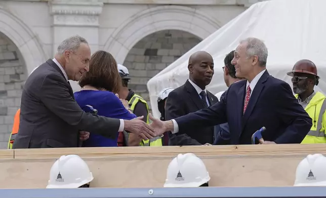 House Majority Leader Steve Scalise, R-La., right and Senate Majority Leader Chuck Schumer, D-N.Y., are seen after the First Nail Ceremony marking the beginning of construction of the 2025 Presidential Inauguration platform, on the steps of the Capitol, Wednesday, Sept. 18, 2024, in Washington. (AP Photo/Mariam Zuhaib)