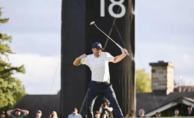 United States team member Keegan Bradley reacts on the 18th green after defeating the international team during a first-round four-ball match at the Presidents Cup golf tournament at the Royal Montreal Golf Club in Montreal, Thursday, Sept. 26, 2024. (Graham Hughes/The Canadian Press via AP)