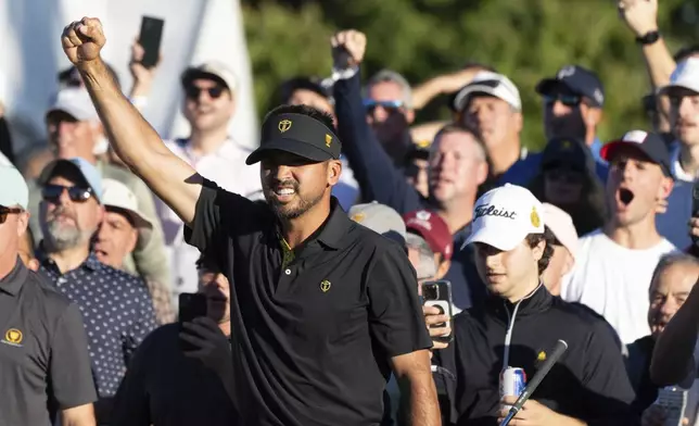 International team member Jason Day of Australia, celebrates after defeating the United States team on the eighteenth hole of their second round foursome match at the Presidents Cup golf tournament at the Royal Montreal Golf Club, in Montreal, Friday, Sept. 27, 2024. (Christinne Muschi/The Canadian Press via AP)