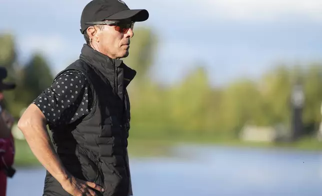 International team captain Mike Weir watches the action on the the 16th hole during a first round four-ball match at the Presidents Cup golf tournament at the Royal Montreal Golf Club in Montreal, Thursday, Sept. 26, 2024. (Christinne Muschi/The Canadian Press via AP)