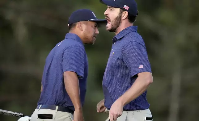 United States team member Patrick Cantlay, right, celebrates with partner Xander Schauffele, left, after winning their fourth-round foursomes match at the Presidents Cup golf tournament at Royal Montreal Golf Club in Montreal, Saturday, Sept. 28, 2024. (Frank Gunn/The Canadian Press via AP)