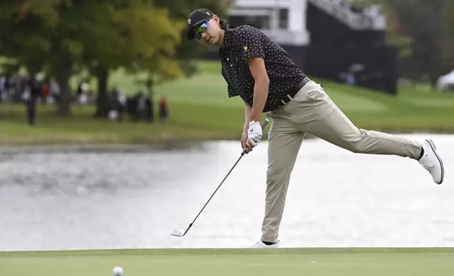 International team member Min Woo Lee, of Australia, reacts to his putt on the 15th green during a first round four-ball match at the Presidents Cup golf tournament at the Royal Montreal Golf Club in Montreal, Thursday, Sept. 26, 2024. (Graham Hughes/The Canadian Press via AP)