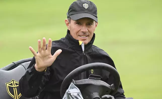 International team captain Mike Weir waves as he leaves the practice range at the Presidents Cup golf tournament, Monday, Sept. 23, 2024, in Montreal. (Graham Hughes/The Canadian Press via AP)