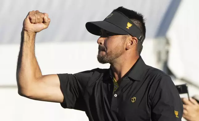 International team member Jason Day of Australia, celebrates after defeating the United States team on the eighteenth hole of their second round foursome match at the Presidents Cup golf tournament at the Royal Montreal Golf Club, in Montreal, Friday, Sept. 27, 2024. (Christinne Muschi/The Canadian Press via AP)