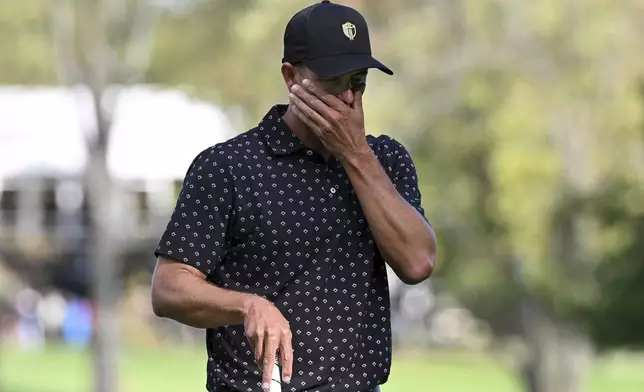 International team member Adam Scott, of Australia, reacts after missing the putt on the 14th green during a first-round four-ball match at the Presidents Cup golf tournament at the Royal Montreal Golf Club in Montreal, Thursday, Sept. 26, 2024. (Graham Hughes/The Canadian Press via AP)