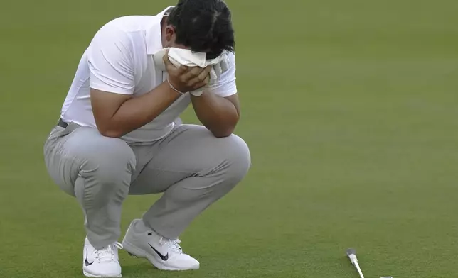 International team member Tom Kim of South Korea, reacts after a poor approach shot on the 16th hole during their fourth round foursomes match at the Presidents Cup golf tournament at Royal Montreal Golf Club Saturday, Sept. 28, 2024 in Montreal. (Nathan Denette/The Canadian Press via AP)