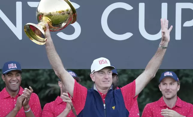 United States team captain Jim Furyk hoists the Presidents Cup after winning at Royal Montreal Golf Club, Sunday, Sept. 29, 2024, in Montreal. (Frank Gunn/The Canadian Press via AP)