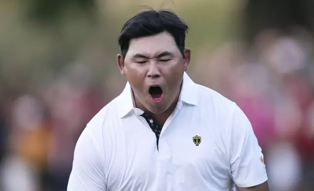 International team member Si Woo Kim of South Korea, celebrates after chipping in to win the 16th hole during their fourth round foursomes match at the Presidents Cup golf tournament at Royal Montreal Golf Club Saturday, September 28, 2024 in Montreal. (Nathan Denette/The Canadian Press via AP)