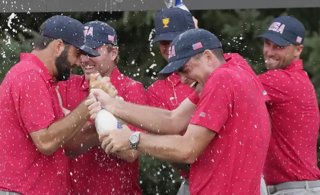 United States team member Keegan Bradley celebrates with teammates after winning the Presidents Cup golf tournament at Royal Montreal Golf Club, Sunday, Sept. 29, 2024, in Montreal. (Frank Gunn/The Canadian Press via AP)