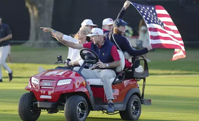 United States team captain Jim Furyk, center front, drives down the 18th fairway after winning the Presidents Cup golf tournament at Royal Montreal Golf Club Sunday, Sept. 29, 2024, in Montreal. (Nathan Denette/The Canadian Press via AP)