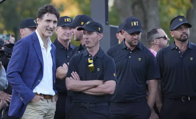 Canada Prime Minister Justin Trudeau chats with International team captain Mike Weir before the trophy presentation at the Presidents Cup golf tournament at Royal Montreal Golf Club Sunday, Sept. 29, 2024 in Montreal. (Christinne Muschi/The Canadian Press via AP)