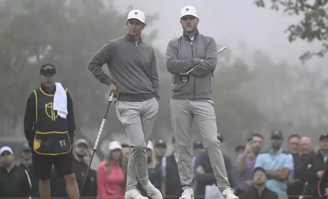 Adam Scott, left, of Australia, and Taylor Pendrith, of Canada, look on at the first green during third round four-ball play at the Presidents Cup golf tournament at Royal Montreal Golf Club, in Montreal, Saturday, Sept. 28, 2024. (Graham Hughes /The Canadian Press via AP)