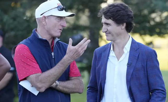 United States team captain Jim Furyk chats with Canada Prime Minister Justin Trudeau before the trophy presentation at the Presidents Cup golf tournament at Royal Montreal Golf Club Sunday, Sept. 29, 2024 in Montreal. (Frank Gunn/The Canadian Press via AP)