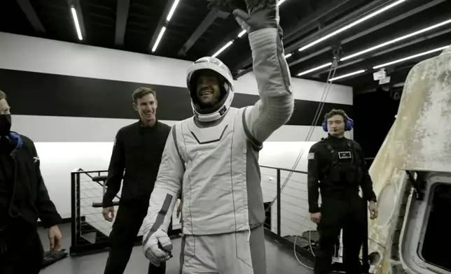 In this image made from SpaceX video, tech entrepreneur Jared Isaacman, center, reacts as he gets out of its capsule upon his return with his crew after the capsule landed in the Gulf of Mexico near Florida's Dry Tortugas early Sunday, Sept. 15, 2024. (SpaceX via AP)