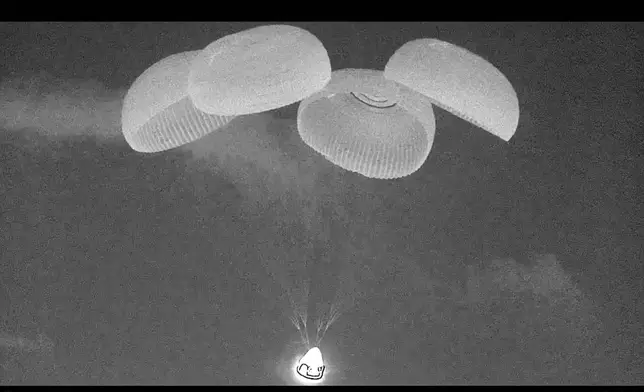 This black and white, thermal image made from SpaceX video shows its capsule, center bottom, carrying tech entrepreneur Jared Isaacman with his crew minutes before it reached the Gulf of Mexico near Florida's Dry Tortugas early Sunday, Sept. 15, 2024. (SpaceX via AP)